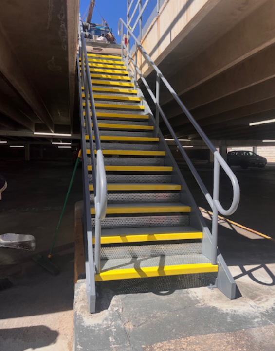 Industrial stairway with safety yellow powder-coated stair nosings