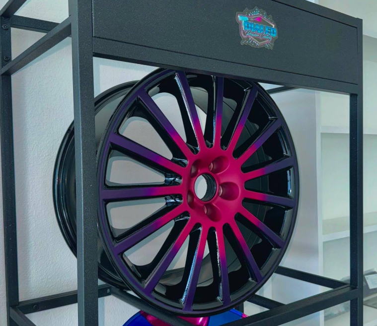 Wheel with custom magenta-to-purple fade powder coat finish on display rack