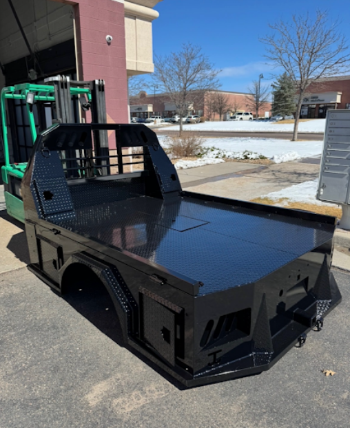 Custom flatbed truck body with gloss black powder coat finish